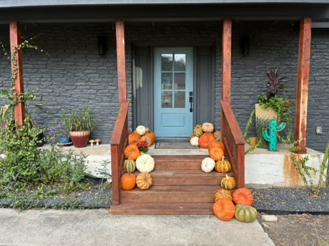 Luxury pumpkin porch on wooden steps with light blue door — real installation