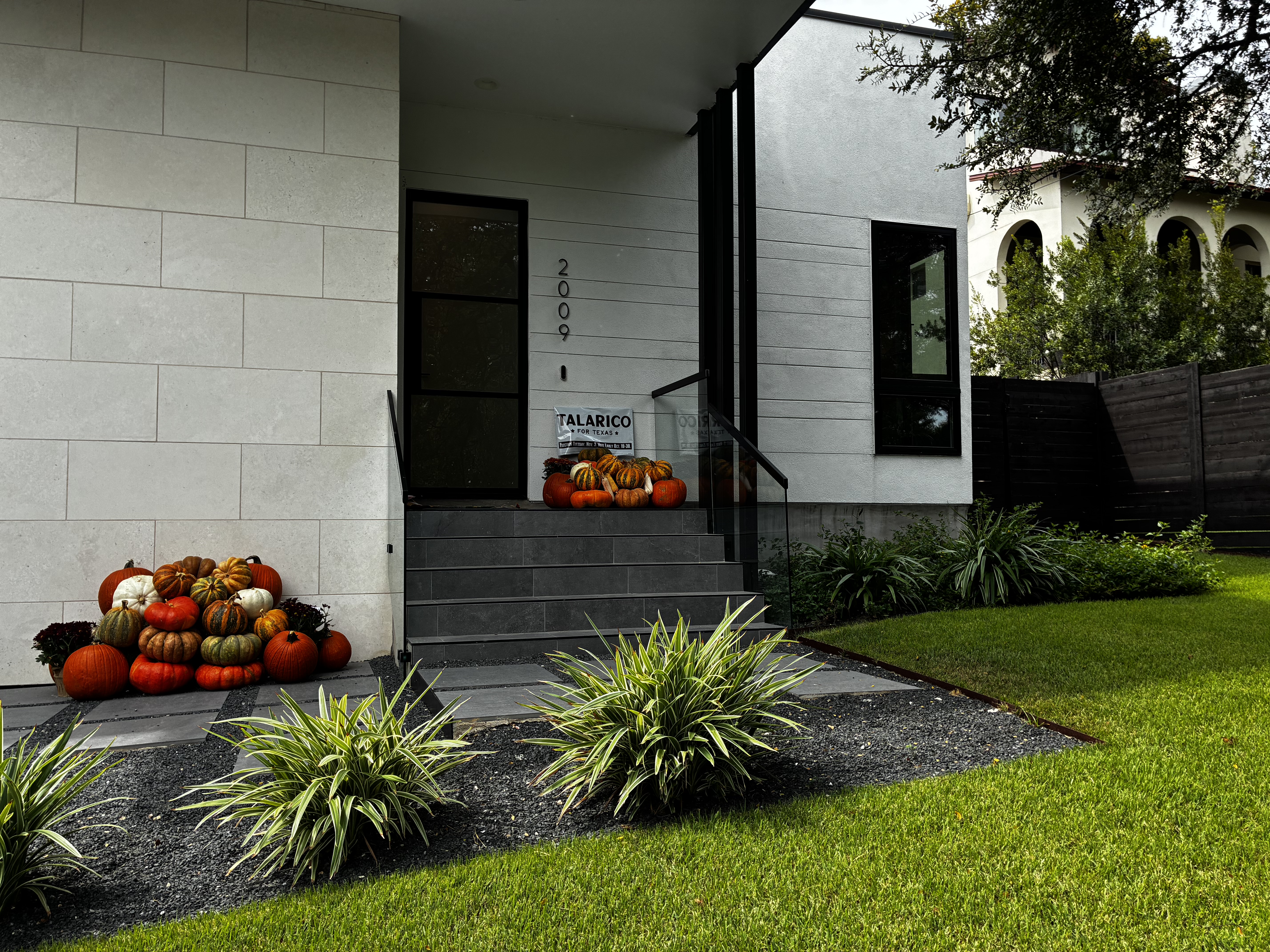 Modern Austin home with Luxury pumpkin display on stone steps — real installation