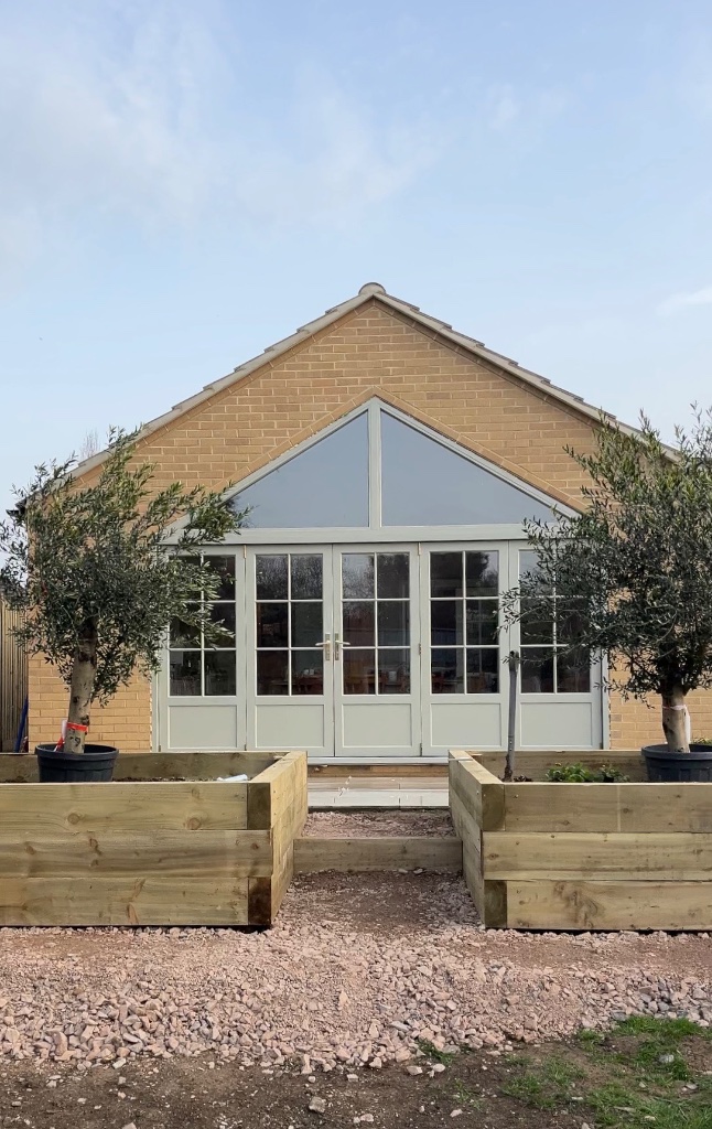 Whole house renovation with gable extension and olive trees