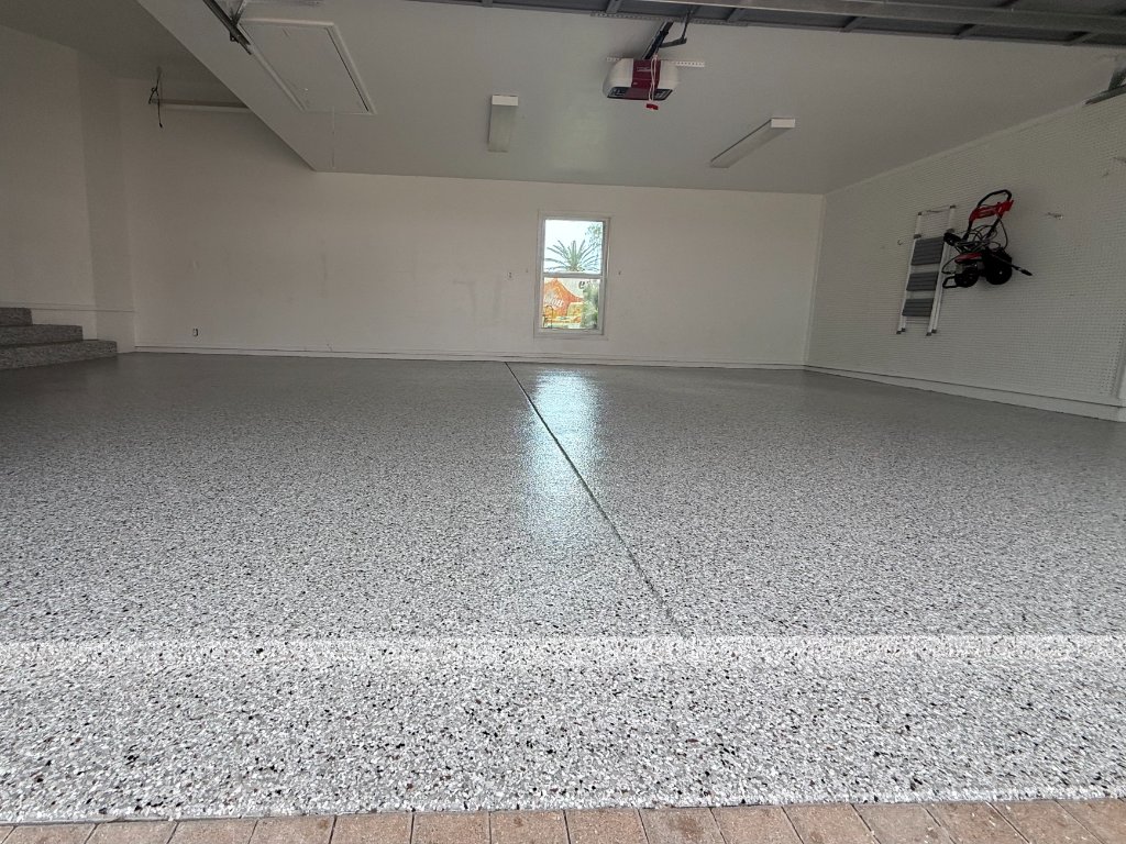 Finished epoxy garage floor with grey and white fleck coating