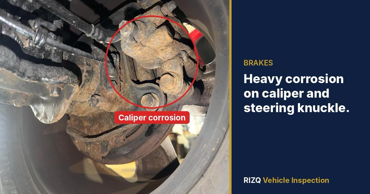 Caliper and steering knuckle corrosion found by a RIZQ inspector on a dealer auction vehicle