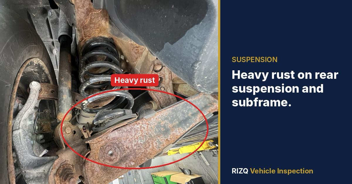A RIZQ inspector documenting the underside of a used vehicle