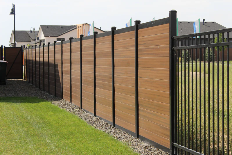 Quantum fence with mocha wood composite infill in a black aluminum frame