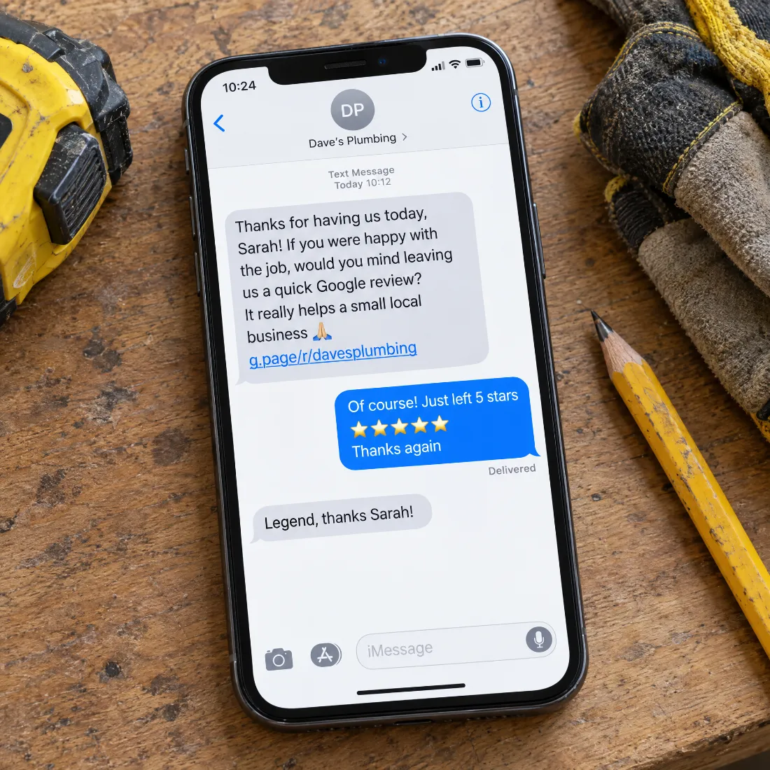 Phone on a workbench showing a review request SMS conversation