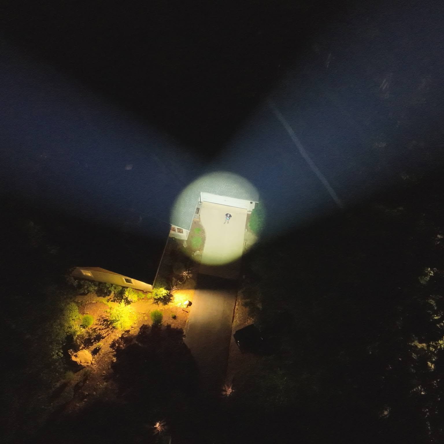 Nighttime driveway spotlight aerial