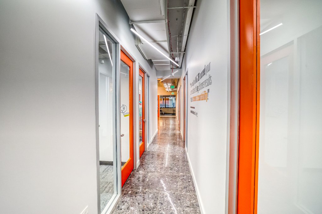 Suites — Orange Door Corridor with Inspirational Quote