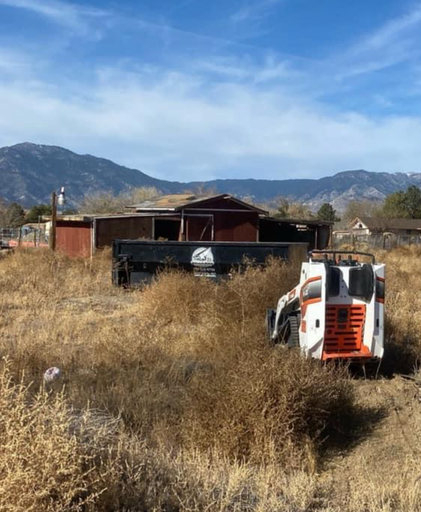 Land cleanup with skid steer and dumpster