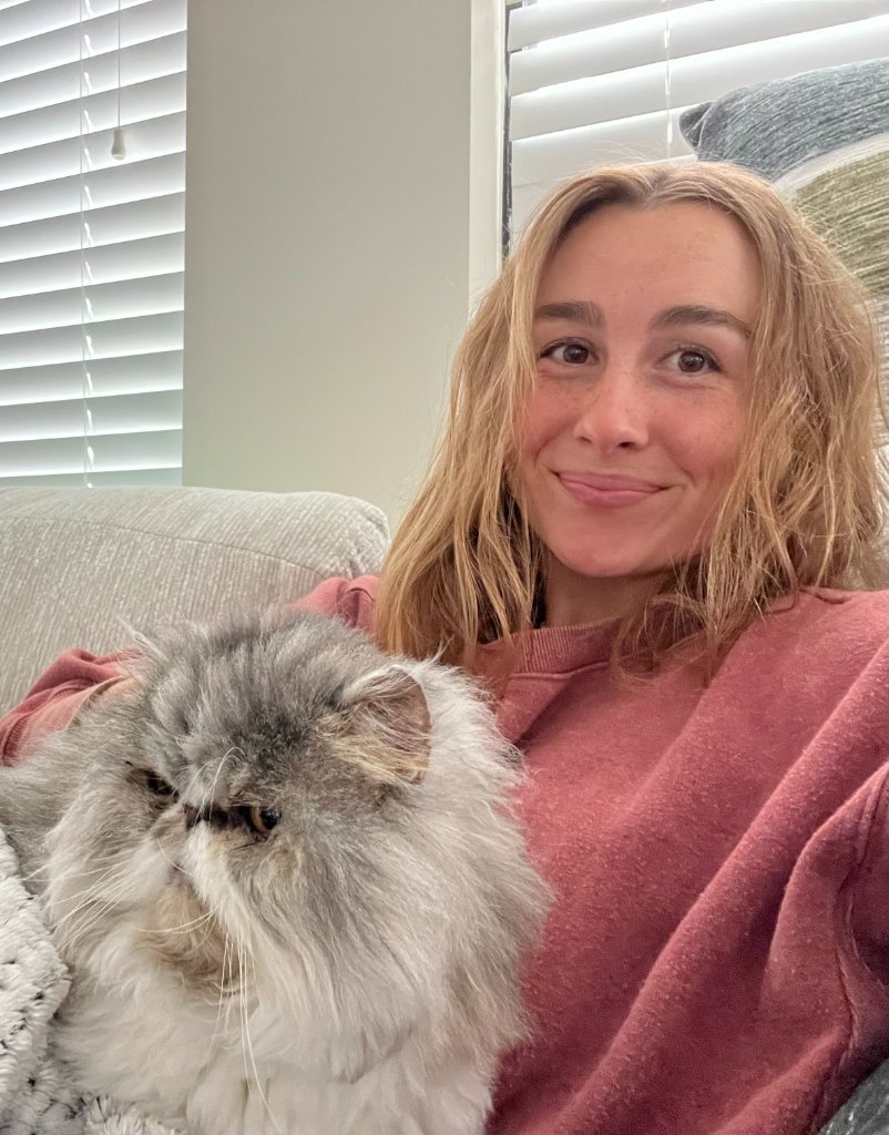 Chloe with a fluffy grey cat