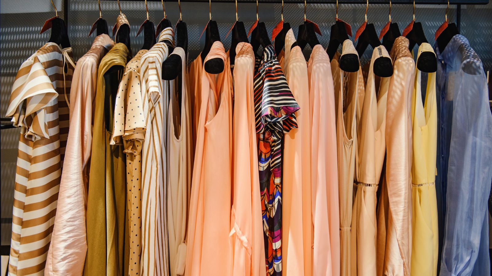 Clothes on racks in a fashion boutique. Real photograph by Grosescu Alberto Mihai / Getty Images Pro, sourced through Canva. Illustrative stock photo; not a photograph of the venues or services reviewed.