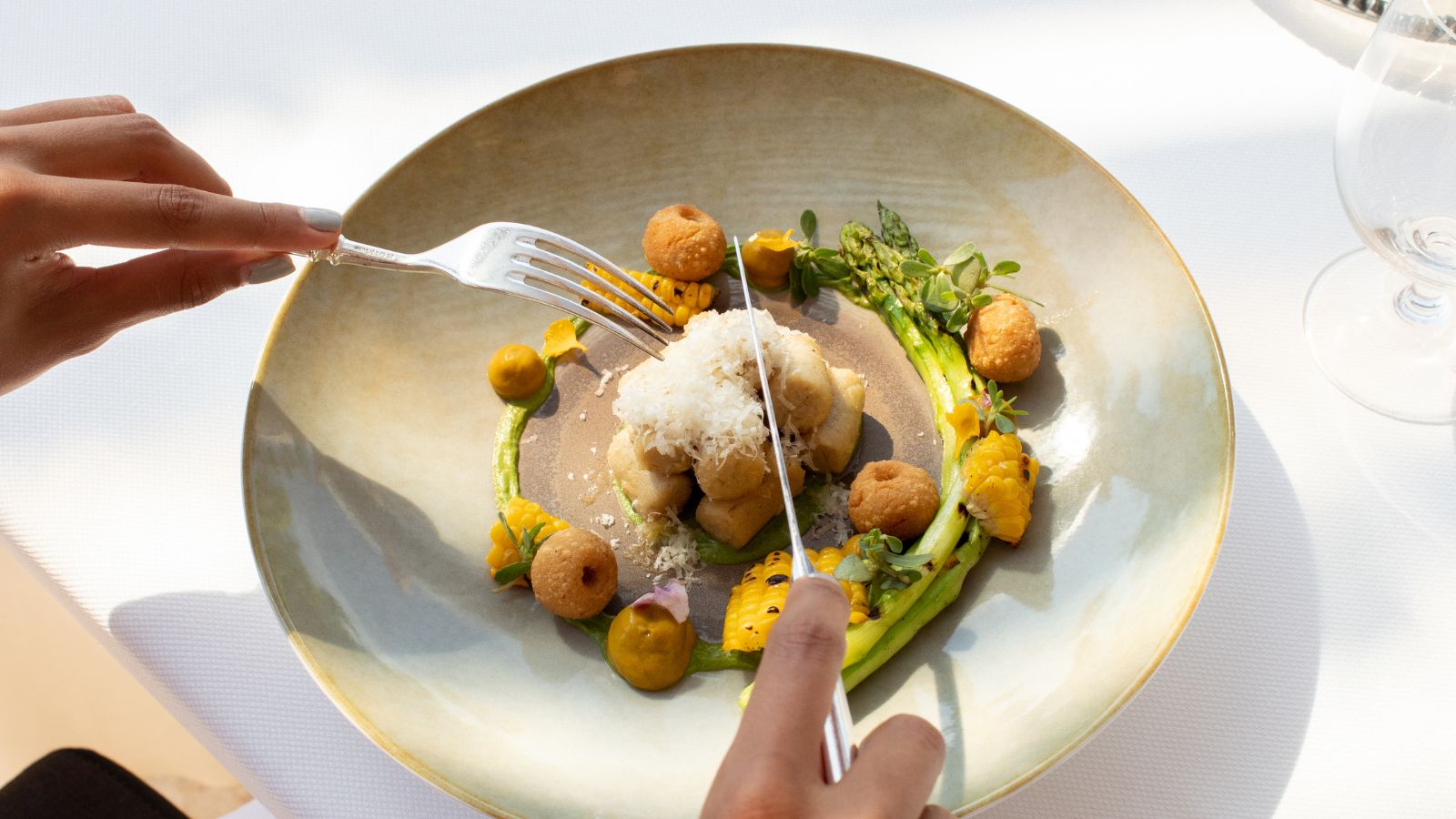 Cutting into fine dining dish. Real photograph by Cavan Images / Getty Images, sourced through Canva. Illustrative stock photo; not a photograph of the venues or services reviewed.