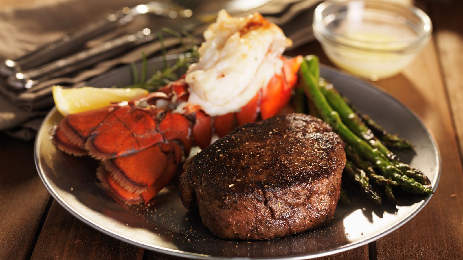 Steak and Lobster. Real photograph by Joshua Resnick, sourced through Canva. Illustrative stock photo; not a photograph of the venues or services reviewed.