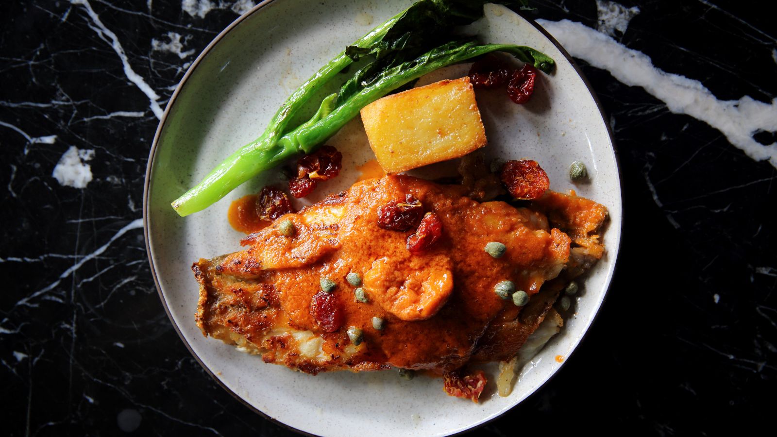 Fine Dining Seabass Fillet with Tomato and Spices Sauce. Real photograph by piyato, sourced through Canva. Illustrative stock photo; not a photograph of the venues or services reviewed.