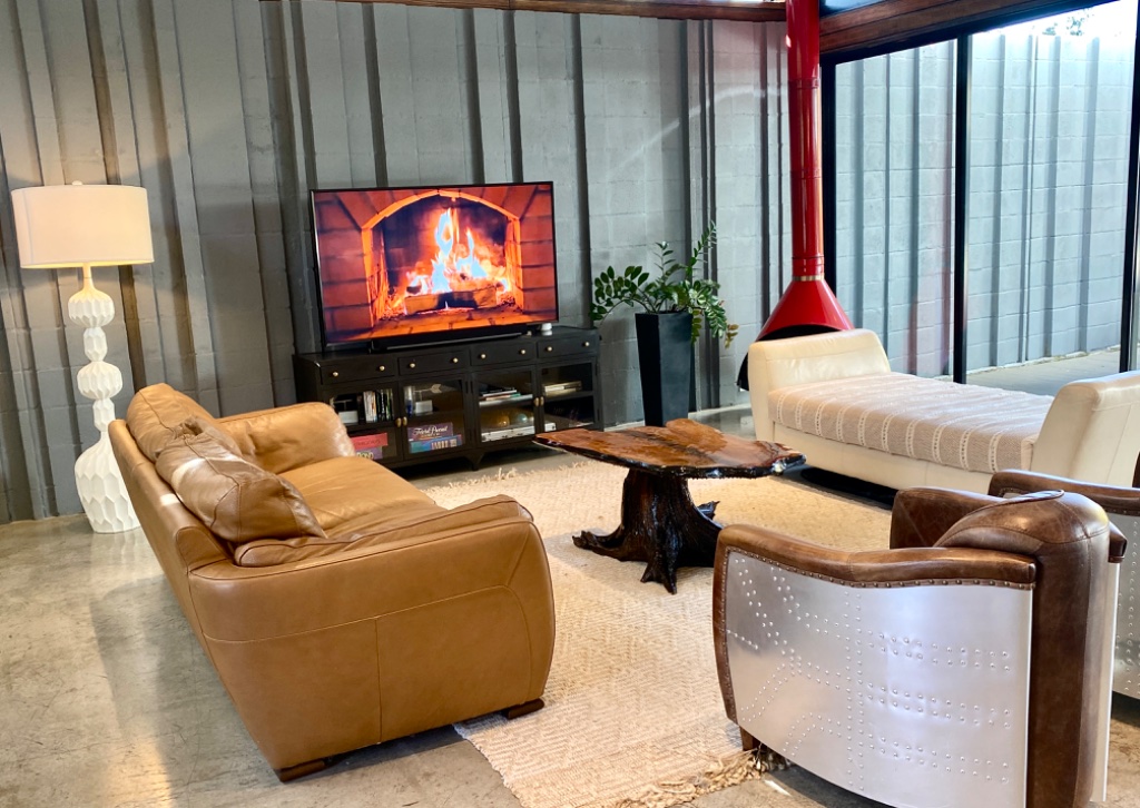 Living area with leather seating and mid-century red fireplace