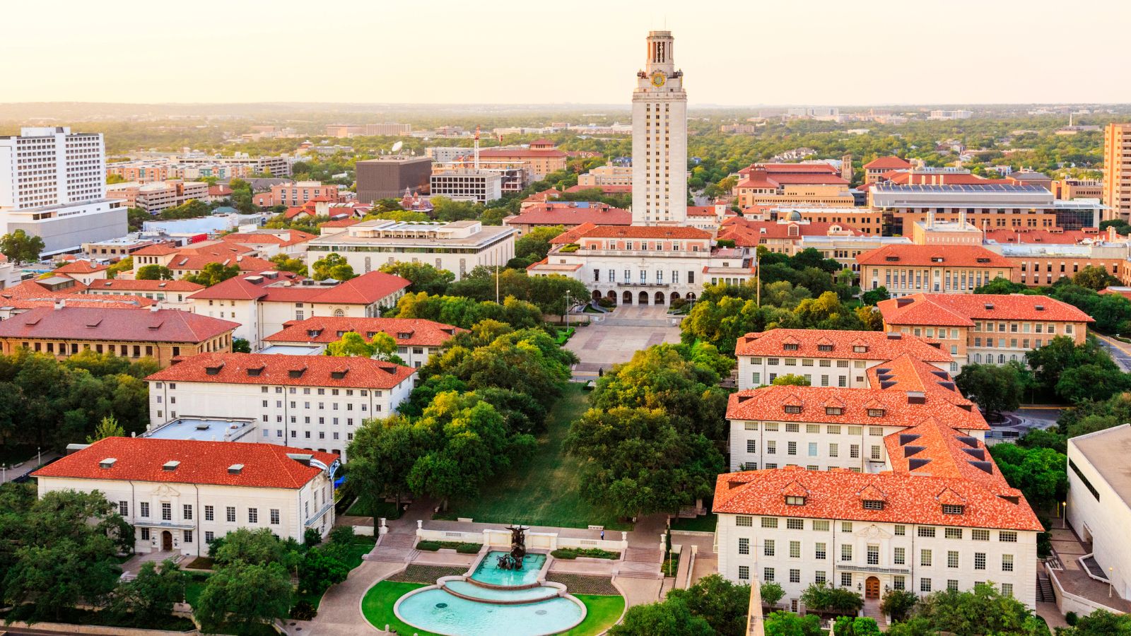 University of Texas (UT) Austin campus at sunset aerial view. Real photograph by dszc / Getty Images Signature, sourced through Canva.
