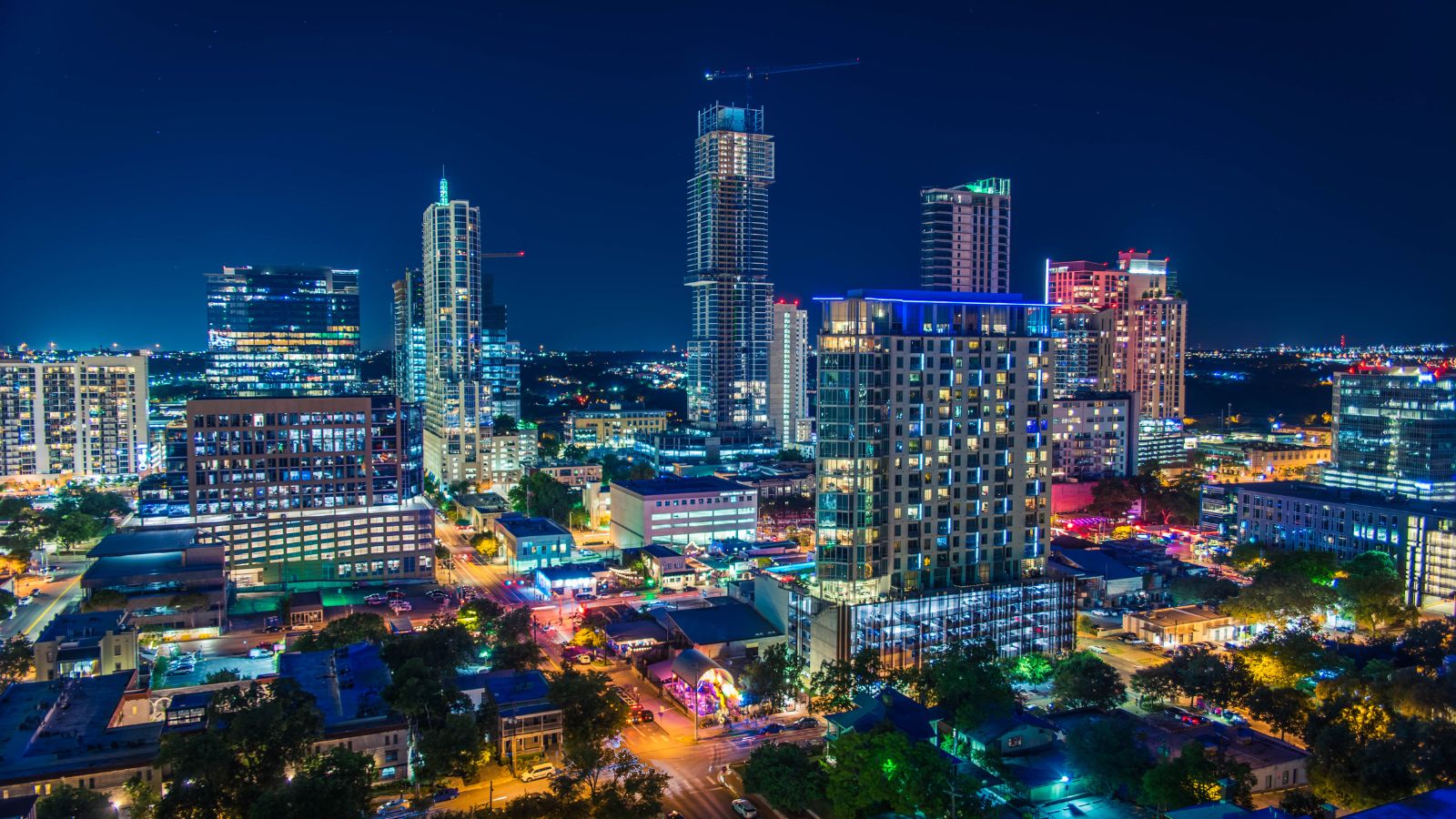 Downtown Austin illuminated at night. Photograph by DifferentMindDesigns / Getty Images Pro, sourced through Canva.