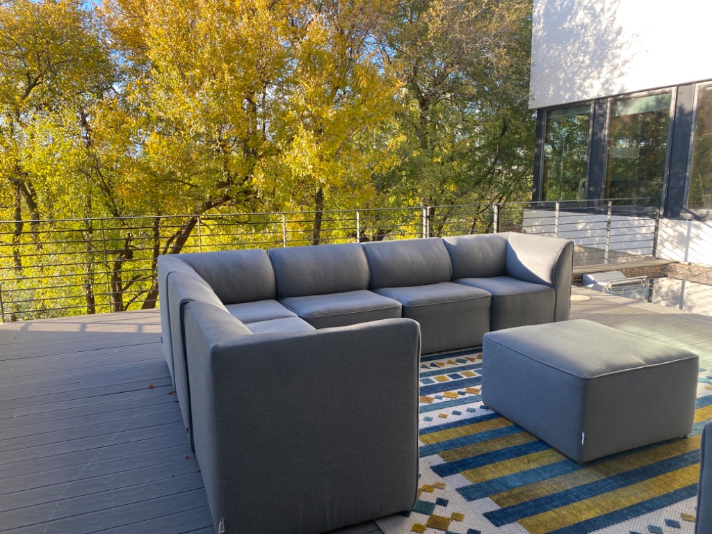 Open-plan dining and living with pool and outdoor deck visible