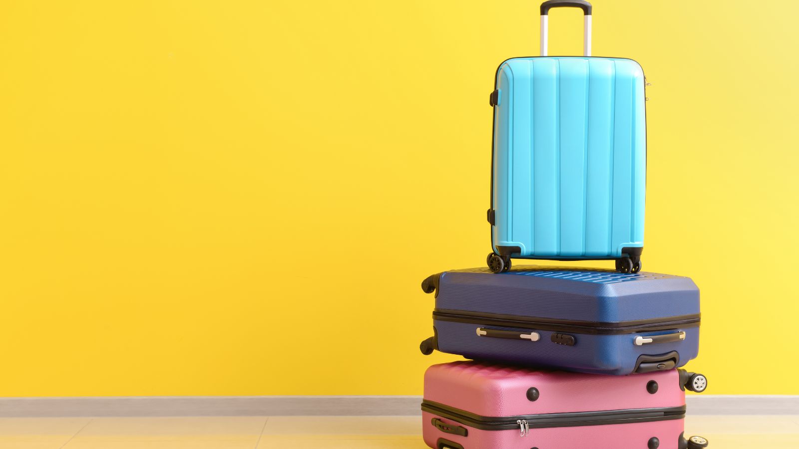 Packed Suitcases near Color Wall. Real photograph by pixelshot, sourced through Canva. Illustrative stock photo; not a photograph of the venues or services reviewed.