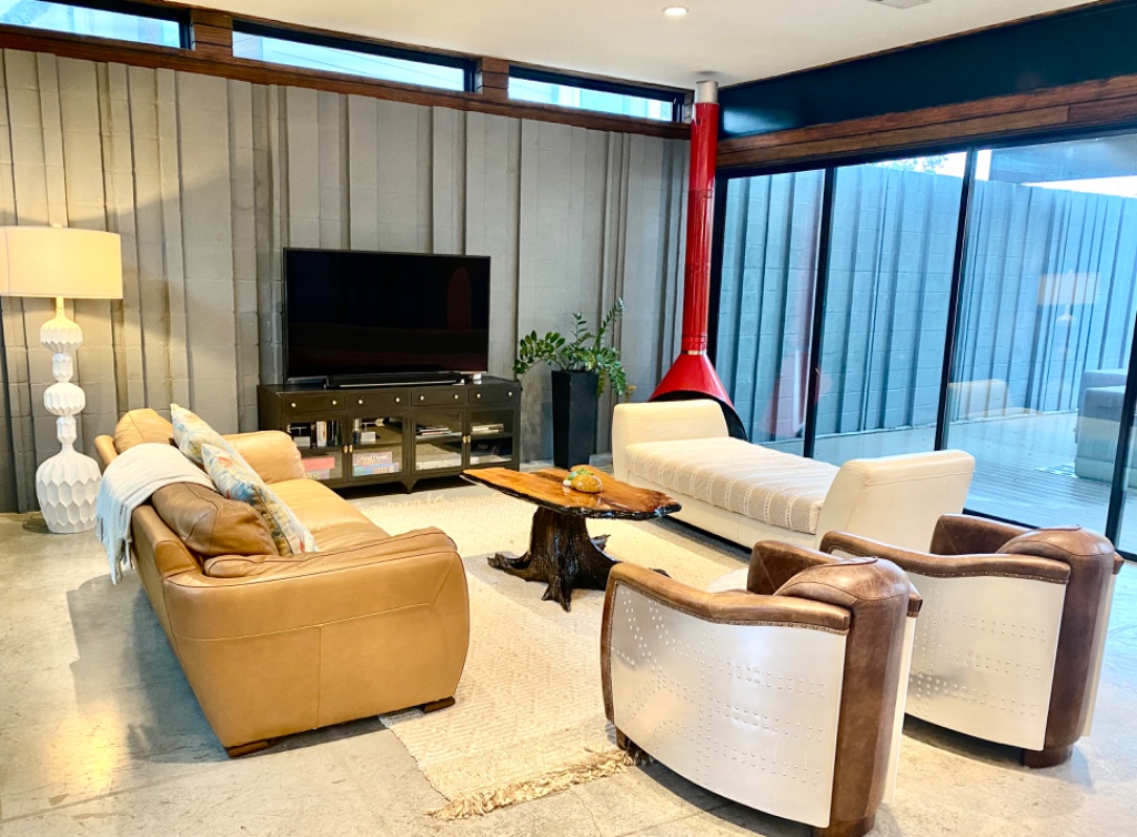 Living area with patio doors that open to pool