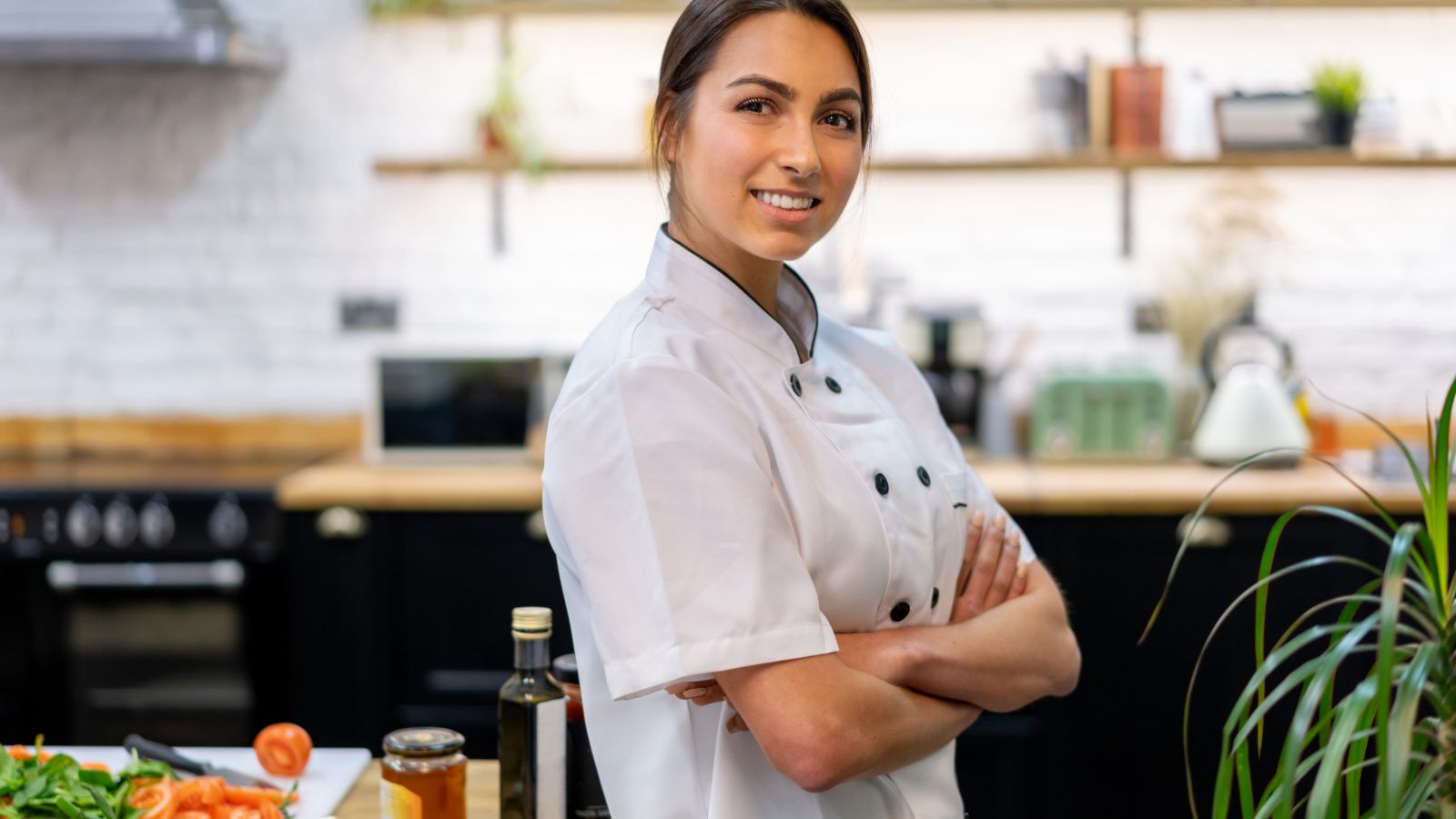 Happy female chef cooking at home. Real photograph by andresr / Getty Images Signature, sourced through Canva. Illustrative stock photo; not a photograph of the venues or services reviewed.