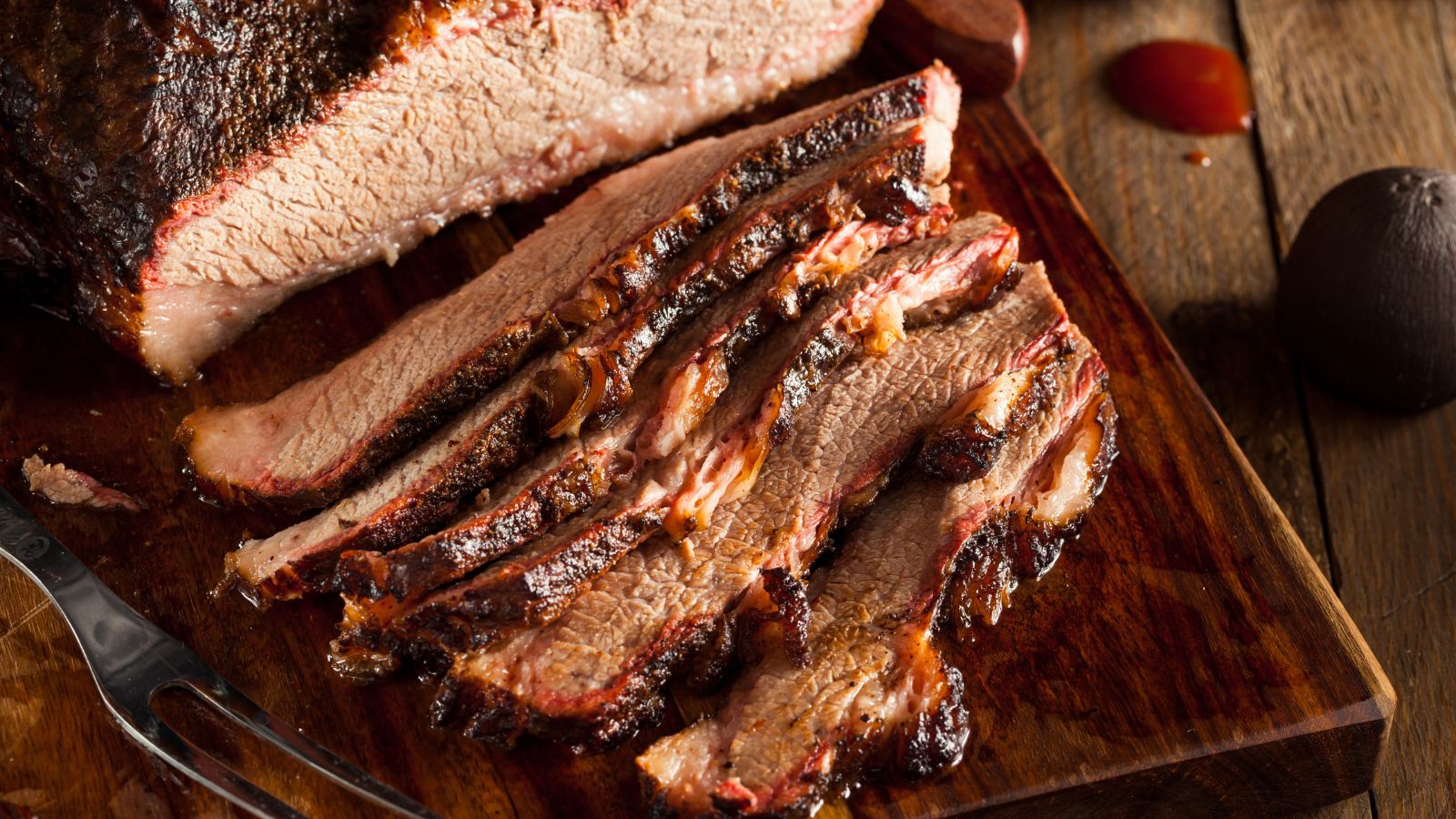 Homemade Smoked Barbecue Beef Brisket. Real photograph by bhofack2 / Getty Images, sourced through Canva. Illustrative stock photo; not a photograph of the venues or services reviewed.