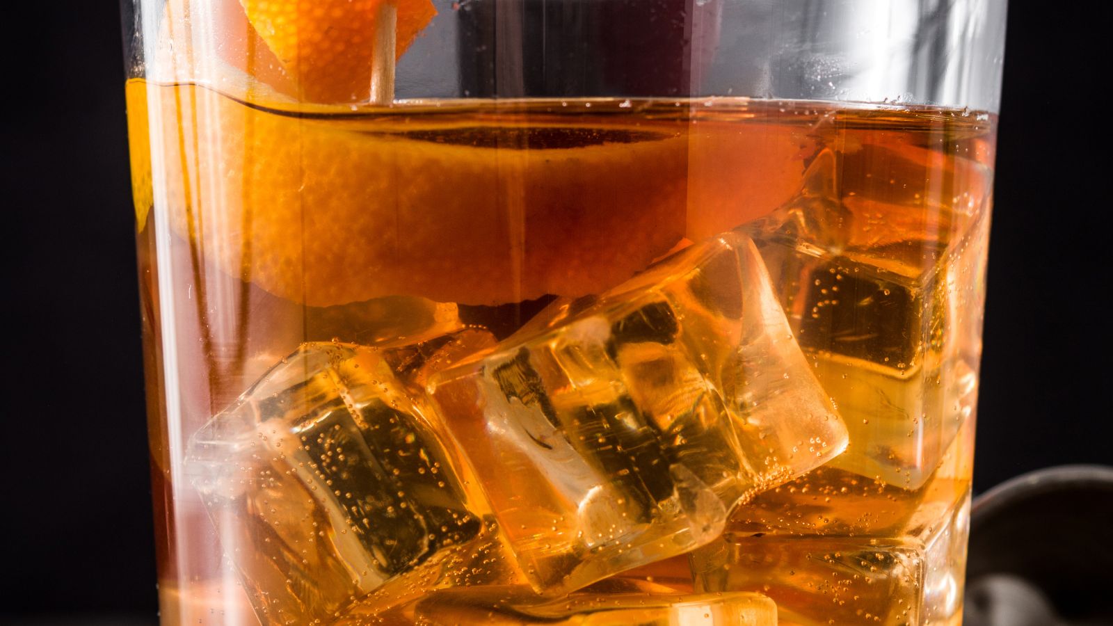 Close-up of an old fashioned cocktail with orange peel and ice. Illustrative photograph by etorres69 / Getty Images, sourced through Canva; not photographed at The Roosevelt Room.