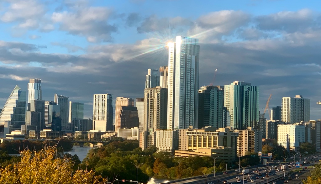 Rooftop outdoor kitchen with stainless grill and Austin skyline