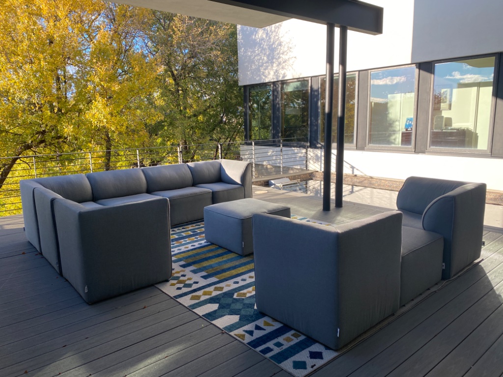 Dining room with blue velvet chairs and view into living room