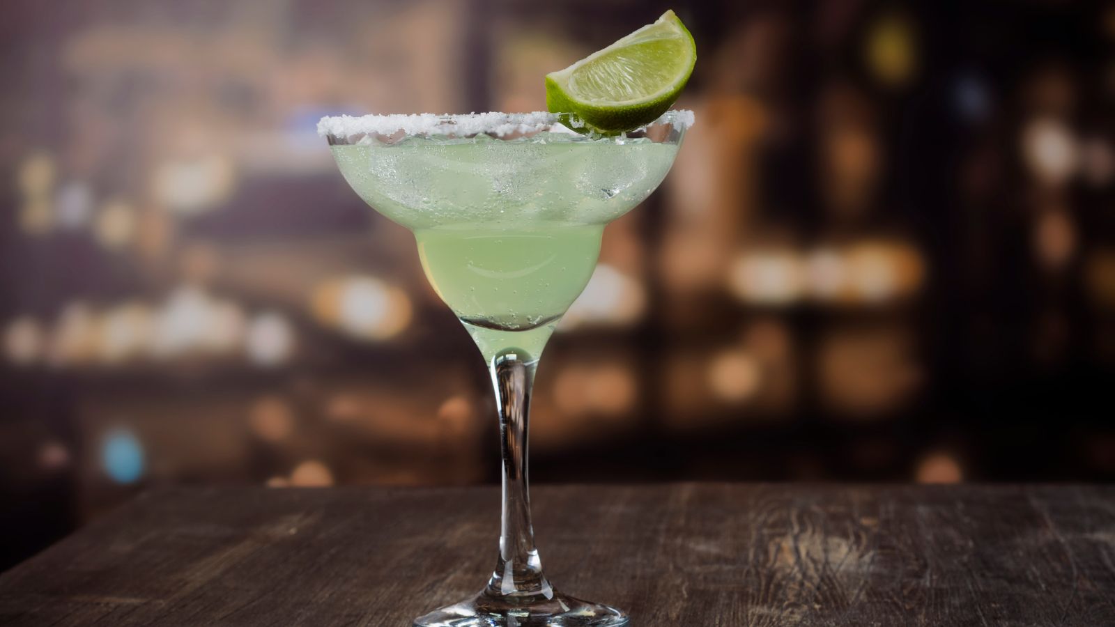 Margarita with lime on a wooden bar table. Illustrative stock photo by happylark, sourced through Canva; not photographed at La Condesa.