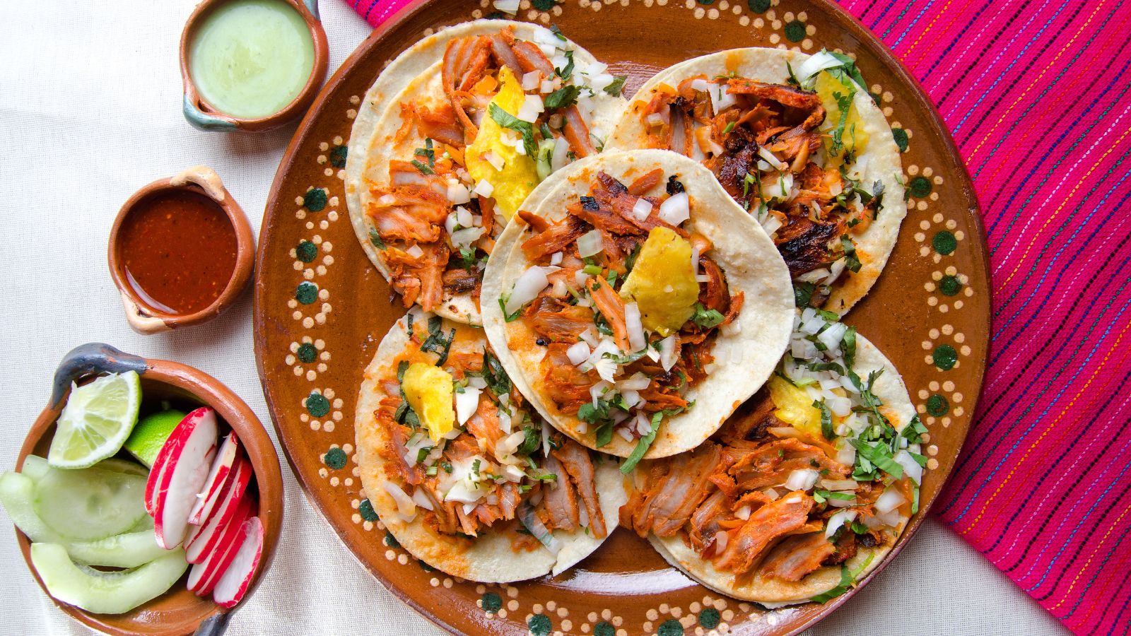 Mexican tacos al pastor. Real photograph by carlosrojas20 / Getty Images Pro, sourced through Canva. Illustrative stock photo; not a photograph of the venues or services reviewed.