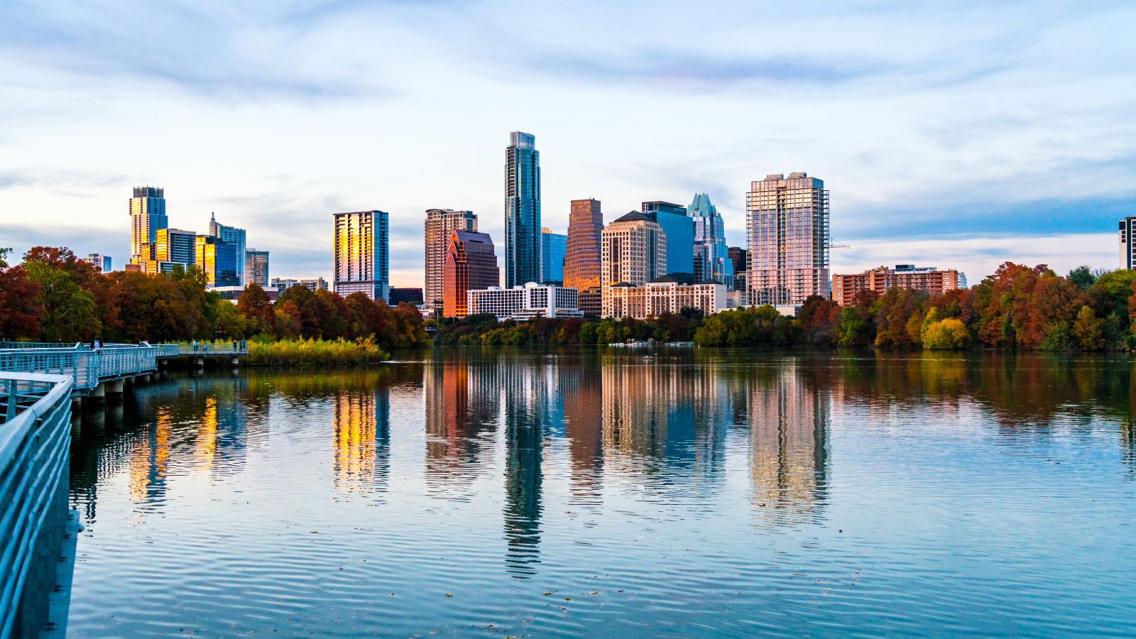 Water reflections at Texas Capital cities Austin , Texas Skyline Cityscape. Real photograph by RoschetzkyIstockPhoto / Getty Images, sourced through Canva.