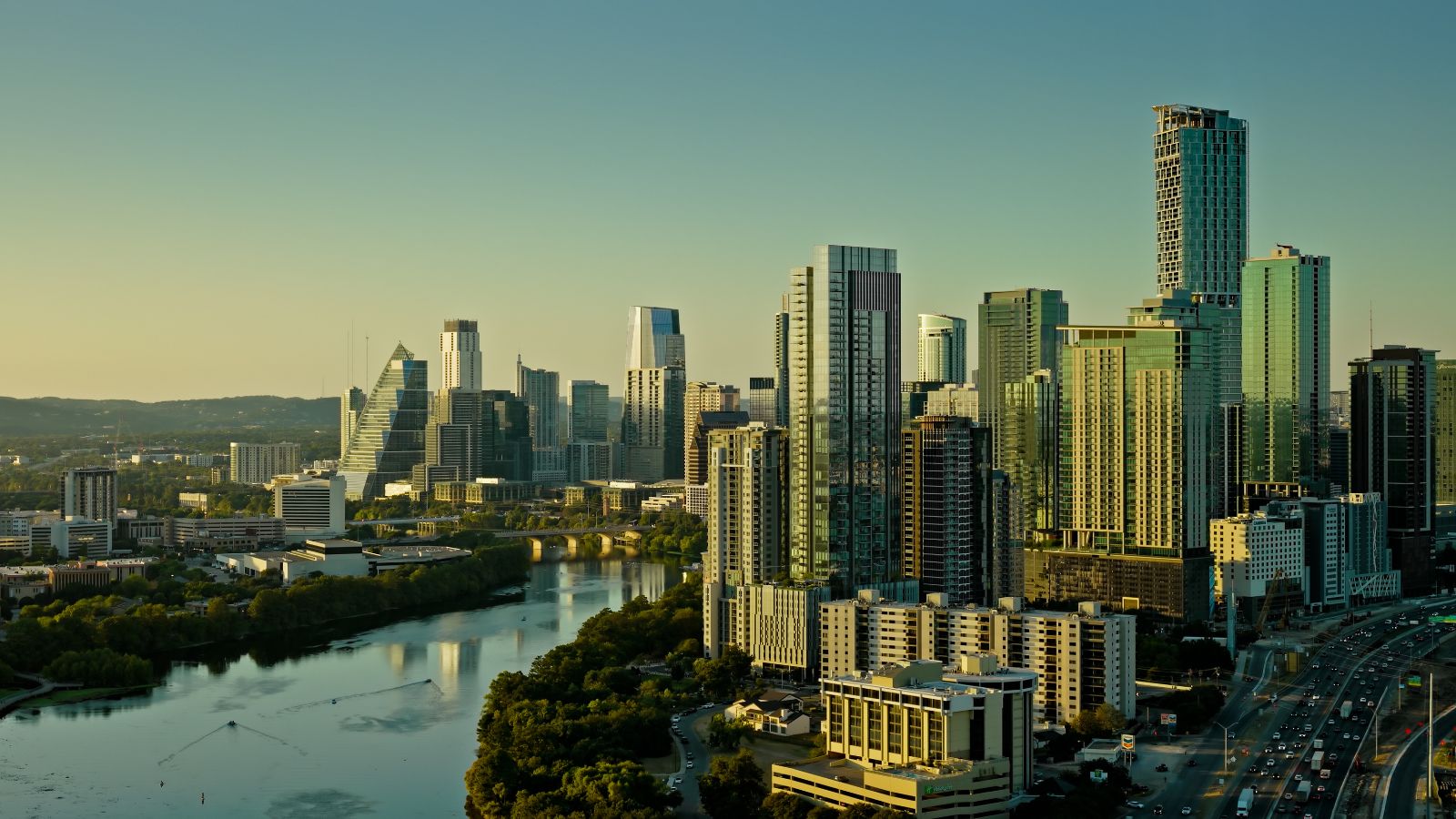 Downtown Austin, TX and Lady Bird Lake at Sunset - Aerial Still Image. Real photograph by halbergman / Getty Images Signature, sourced through Canva.