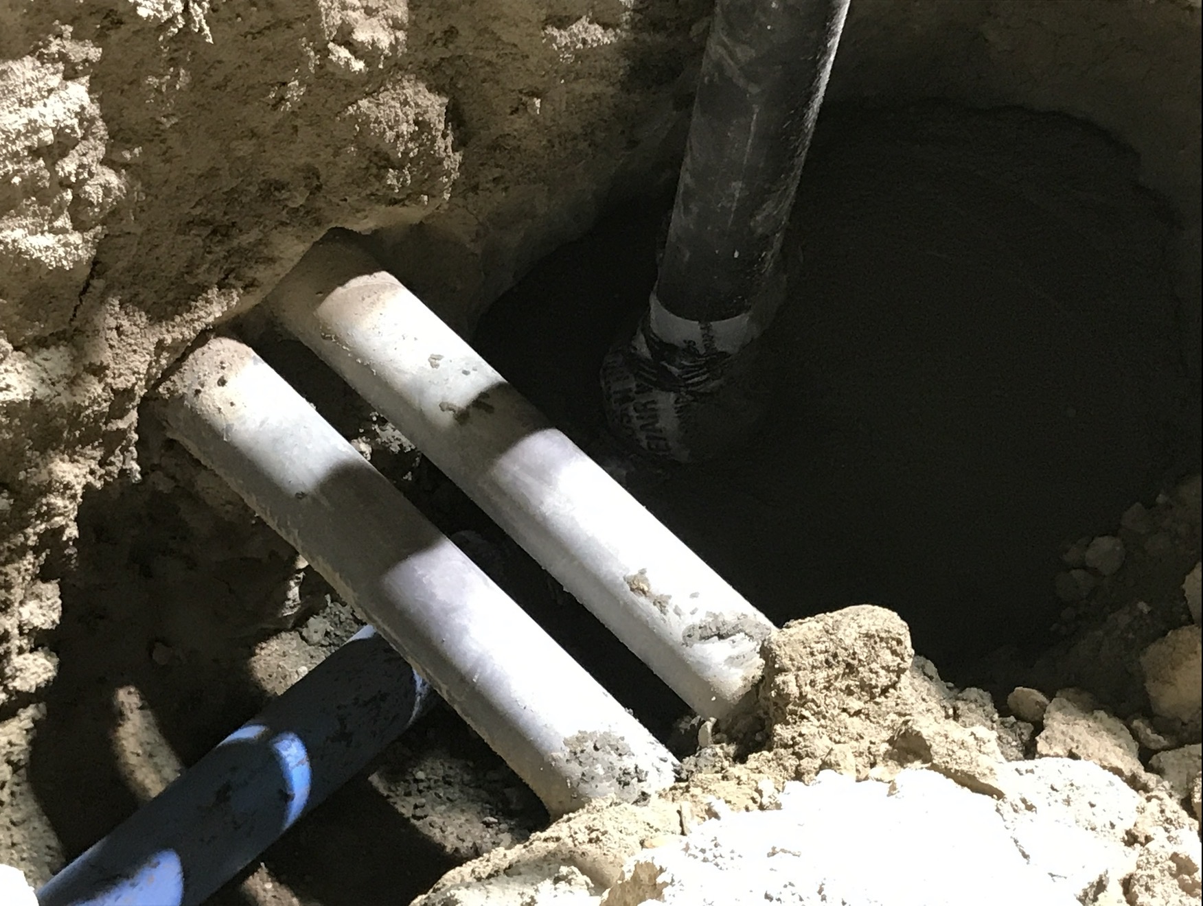 Exposed underground water and utility pipes revealed by hydro excavation