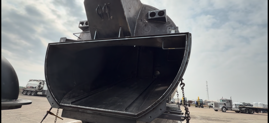 Rear view of unpainted tank on flatbed
