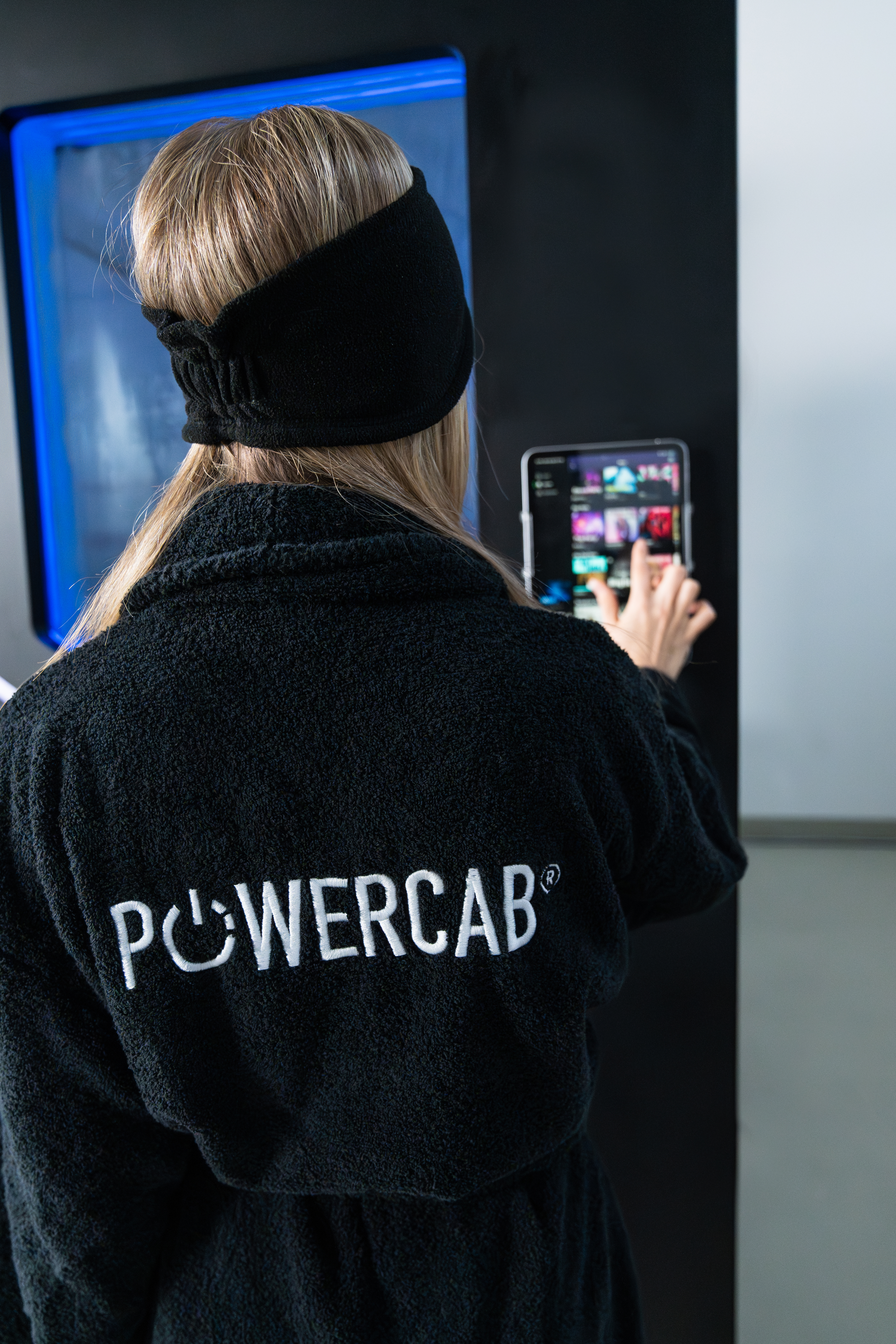 Client using the digital control interface of the POWERCAB STORM cryotherapy chamber