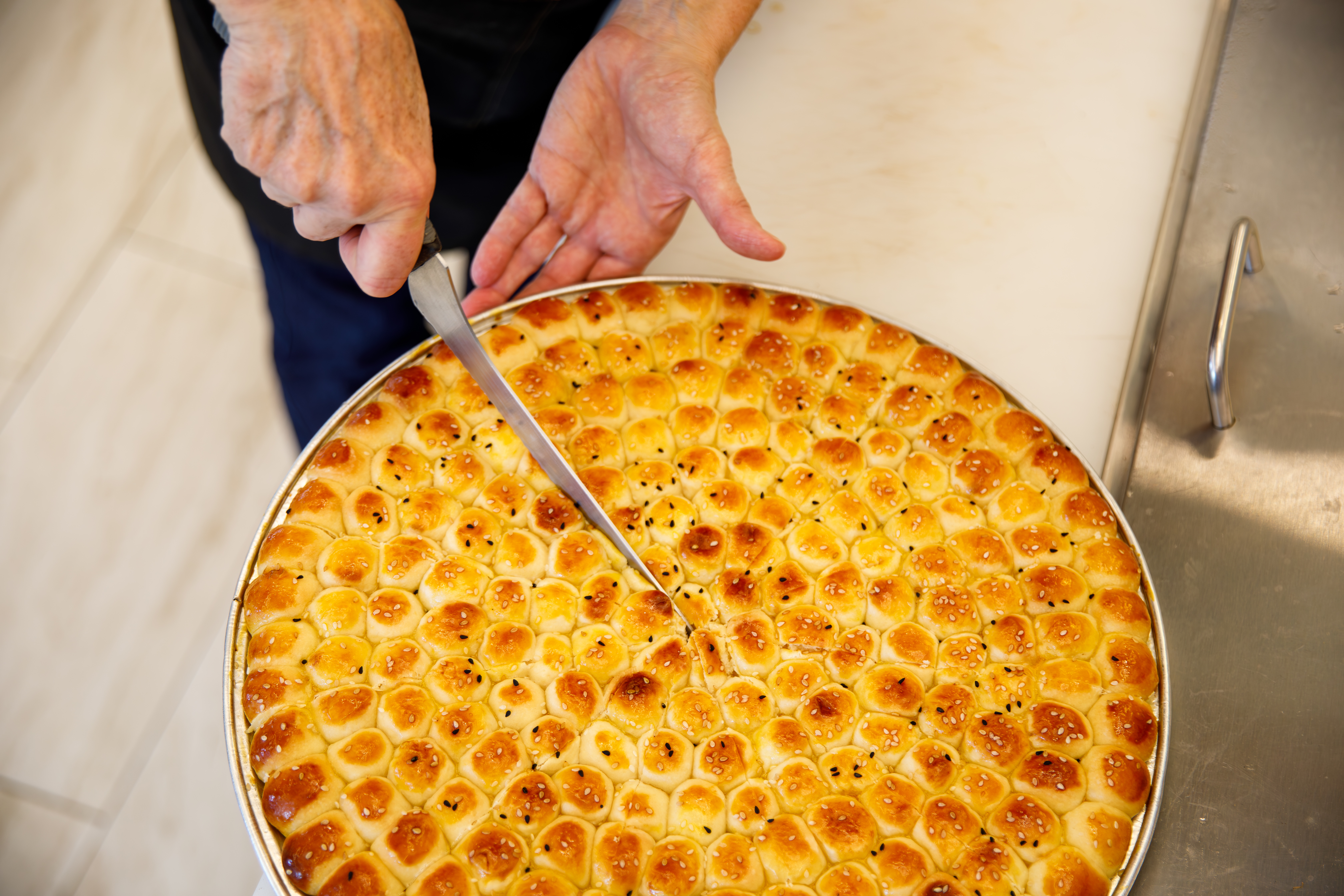 Hand-cutting traditional Yemeni honey-glazed pastries