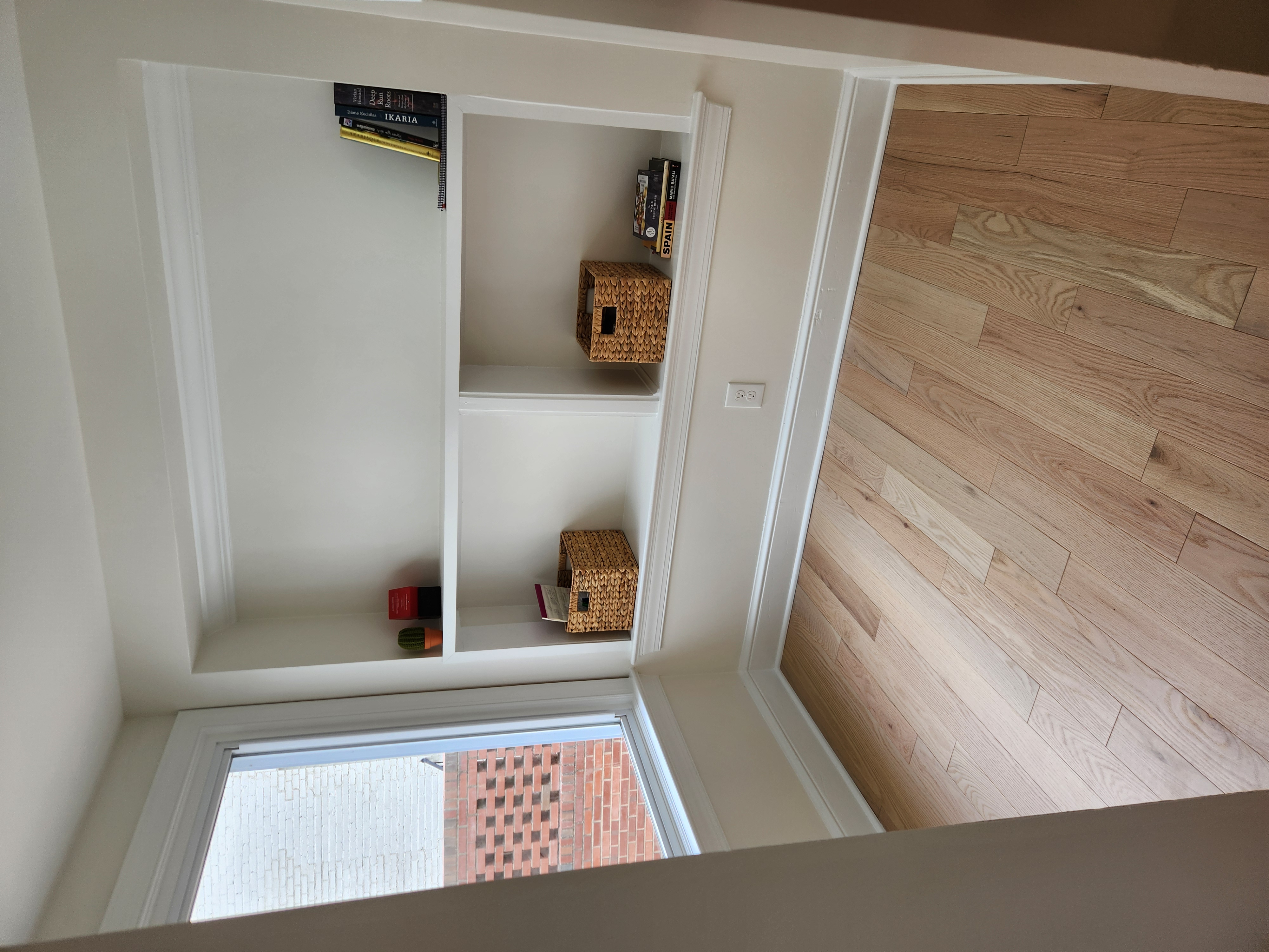 Built-in painted shelving nook with white oak floors in the finished Raleigh remodel