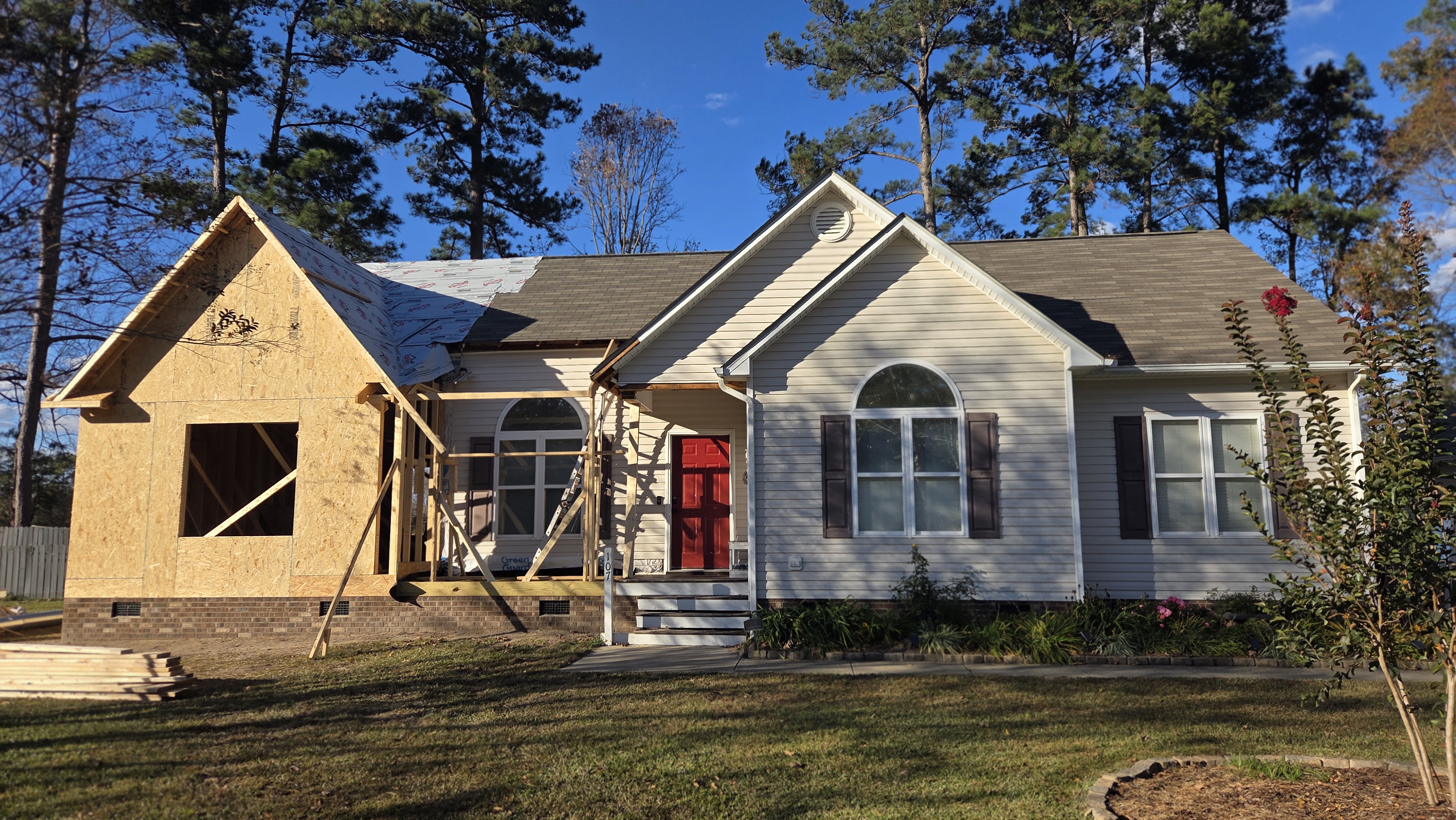 Clayton home addition framed on new brick foundation and tied into the existing roofline