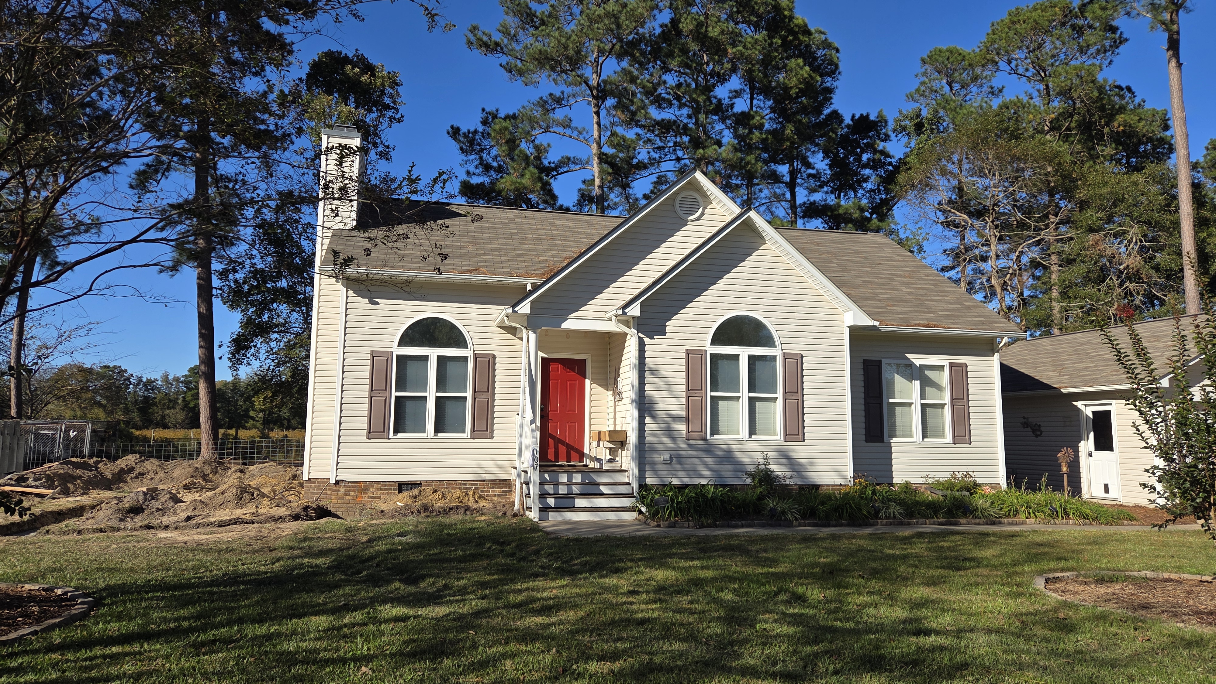 Original Clayton, NC house with red front door before the home addition was built