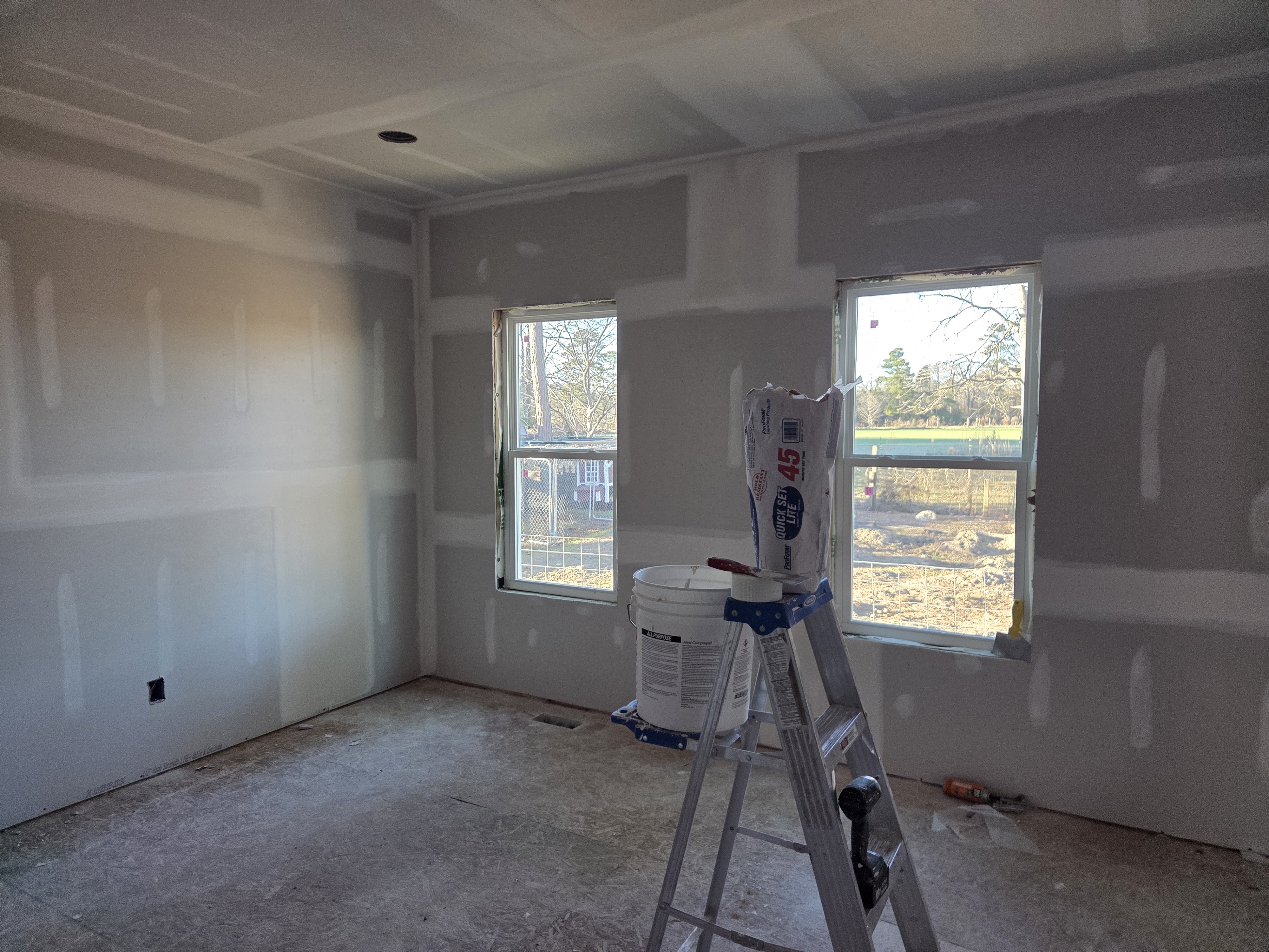 New addition room finished with hung and taped drywall and two new windows