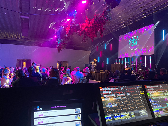 AV technician managing event production at a fundraising gala