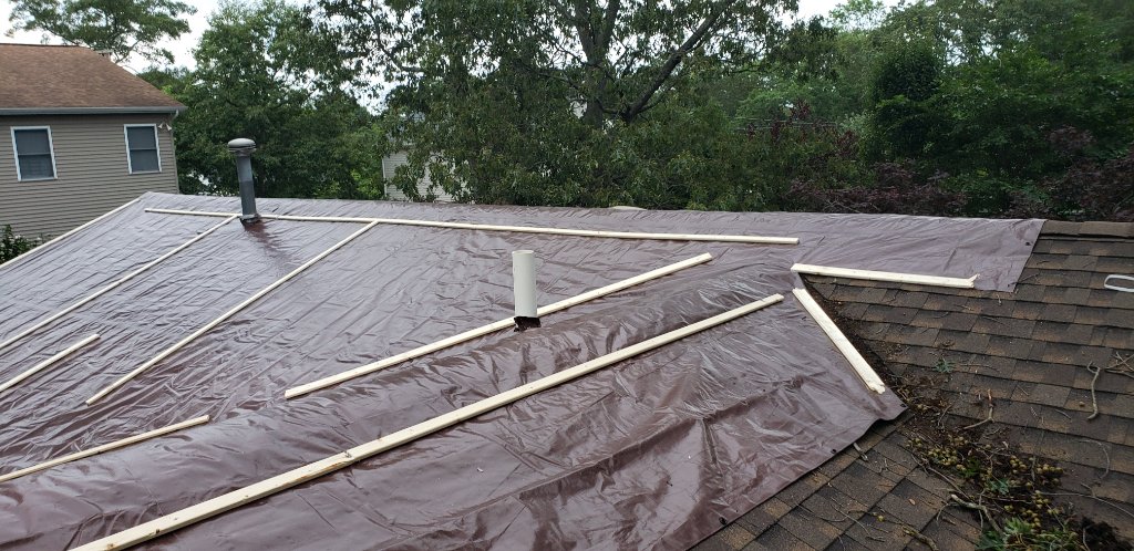 Three Workers On Roof