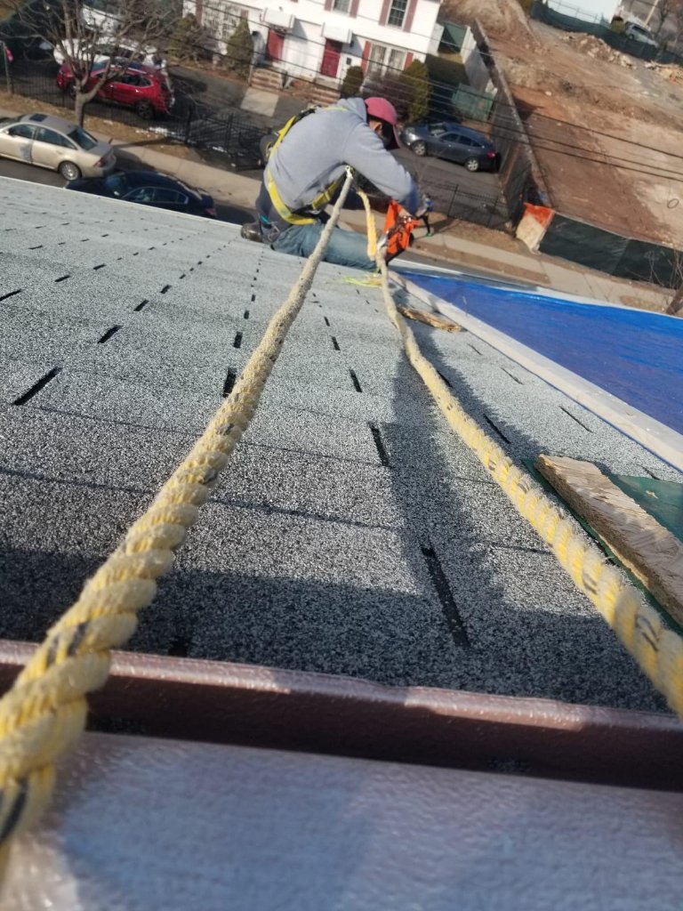 Worker Securing Tarp NJ A