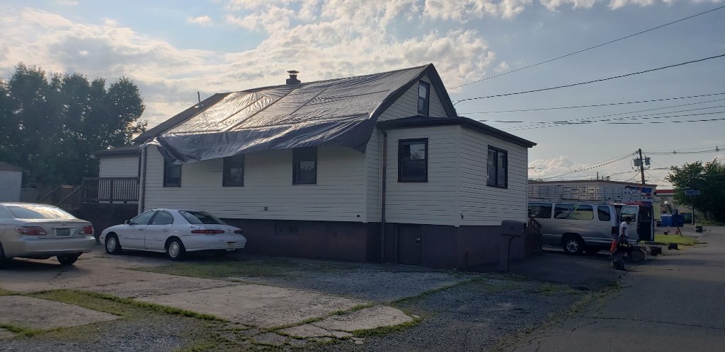 House Tarp Secured — Street