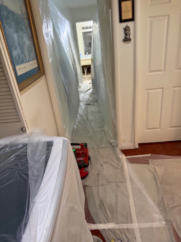 Hallway covered with plastic protection during repipe work
