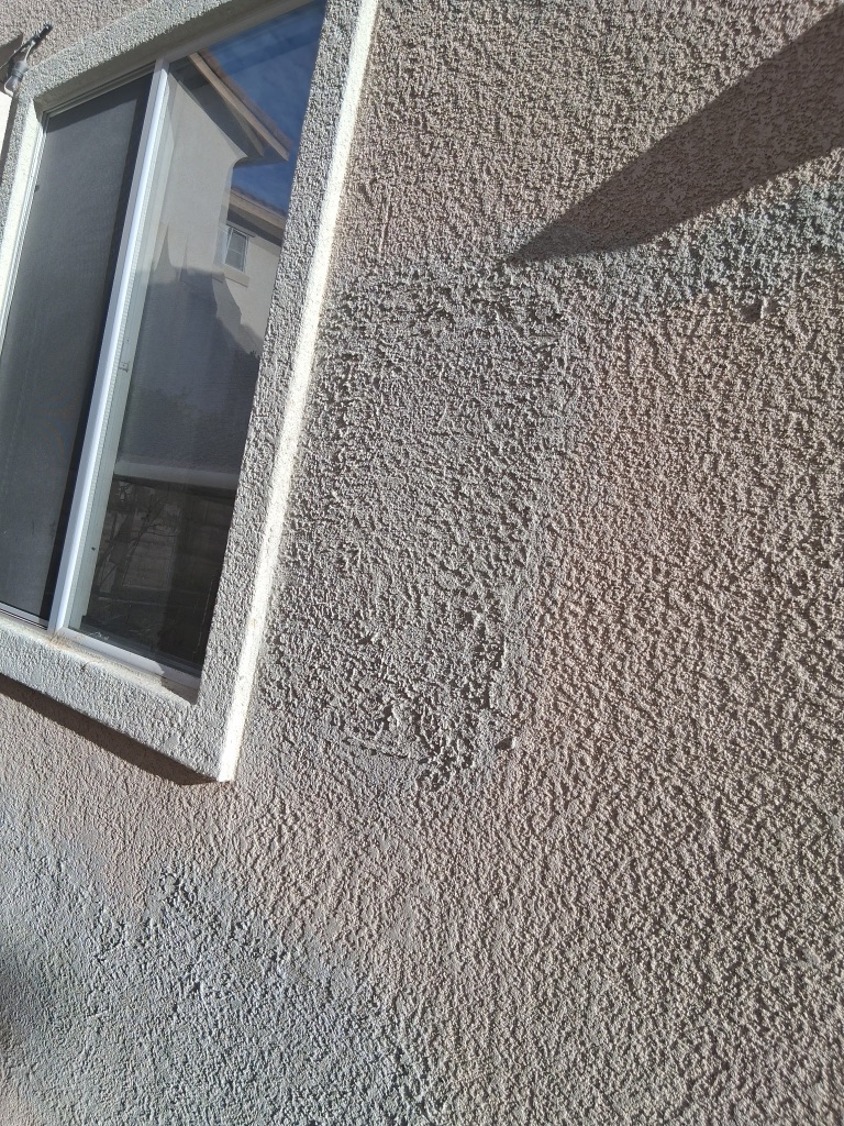 Exterior stucco patch blended and retextured after repipe access opening