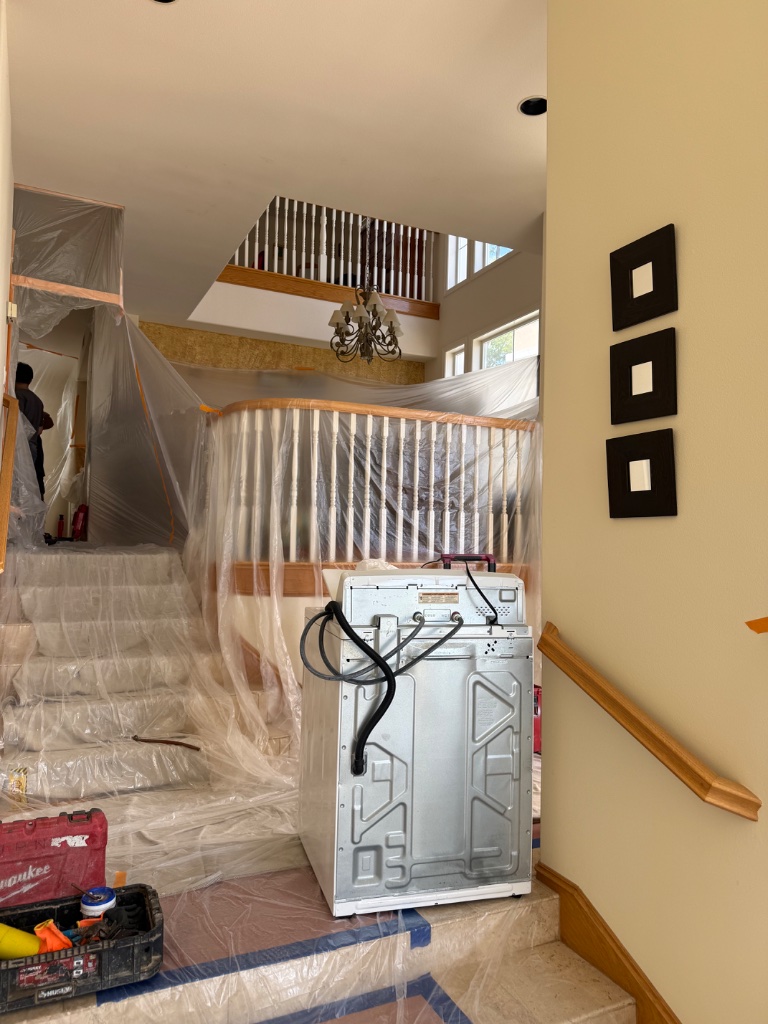 Two-story home interior protected — crew working on upper floor repipe