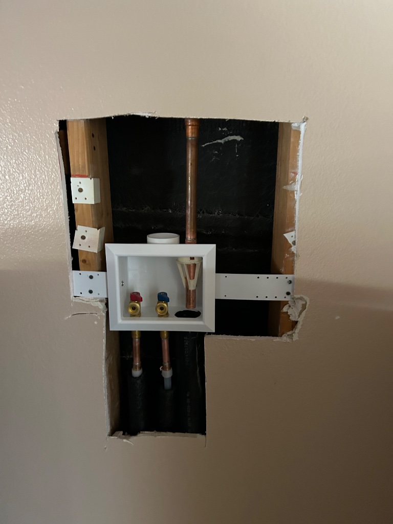 New washer box and copper supply lines installed in wall cavity