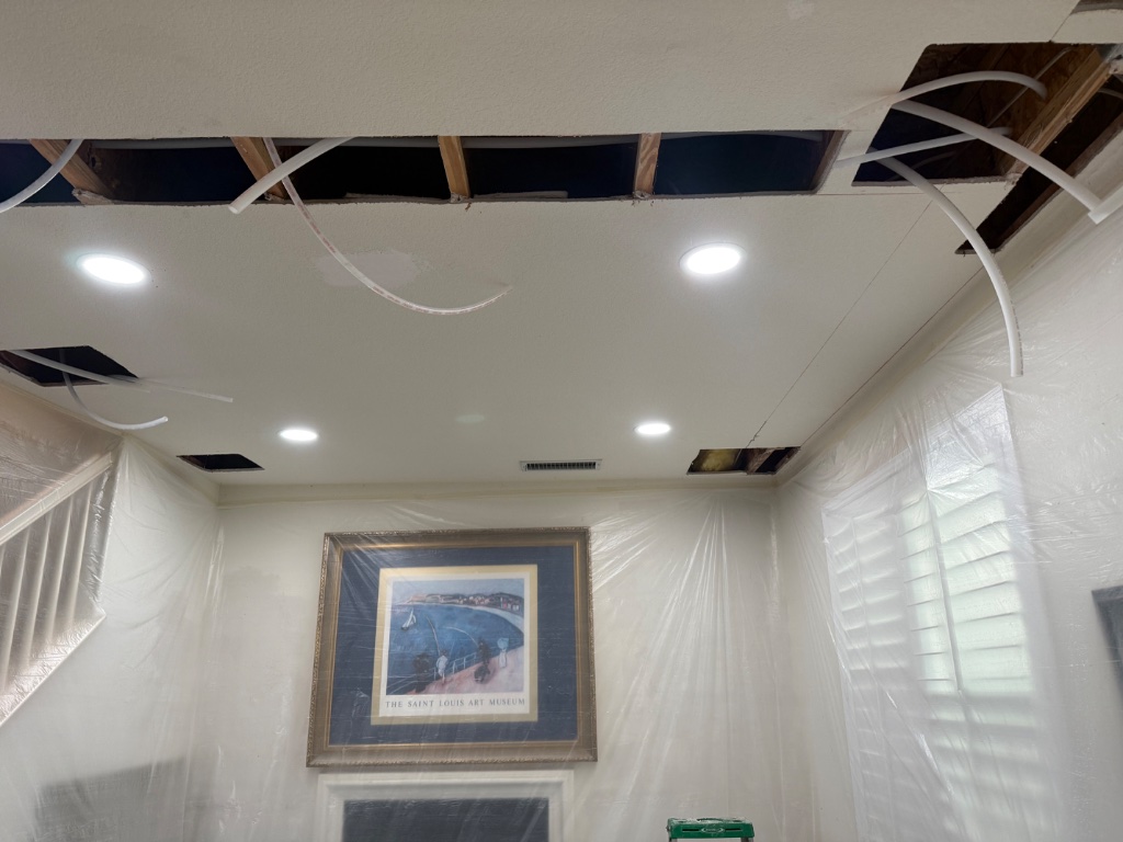Living room ceiling with PEX runs and full plastic drop cloth protection