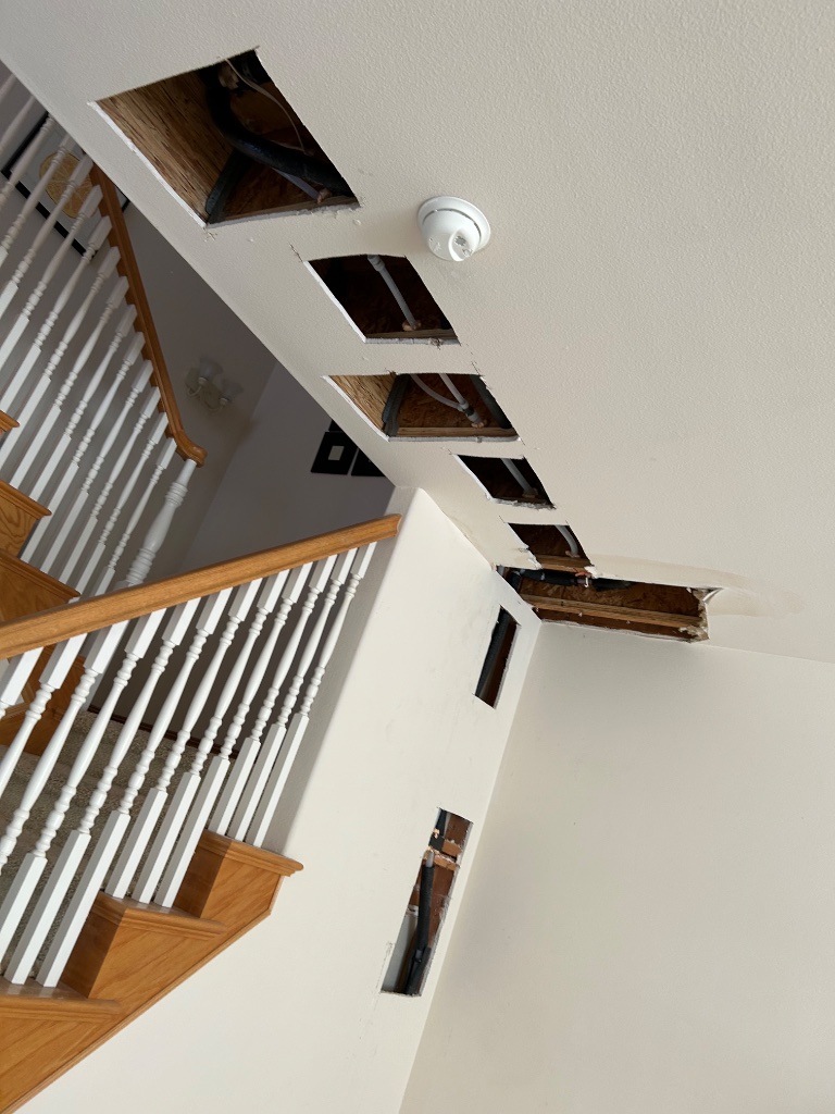 Bathroom sink wall opened showing new copper supply line stub-outs