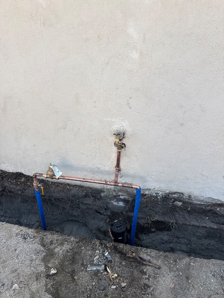 New copper mainline connections and PRV installed at exterior foundation